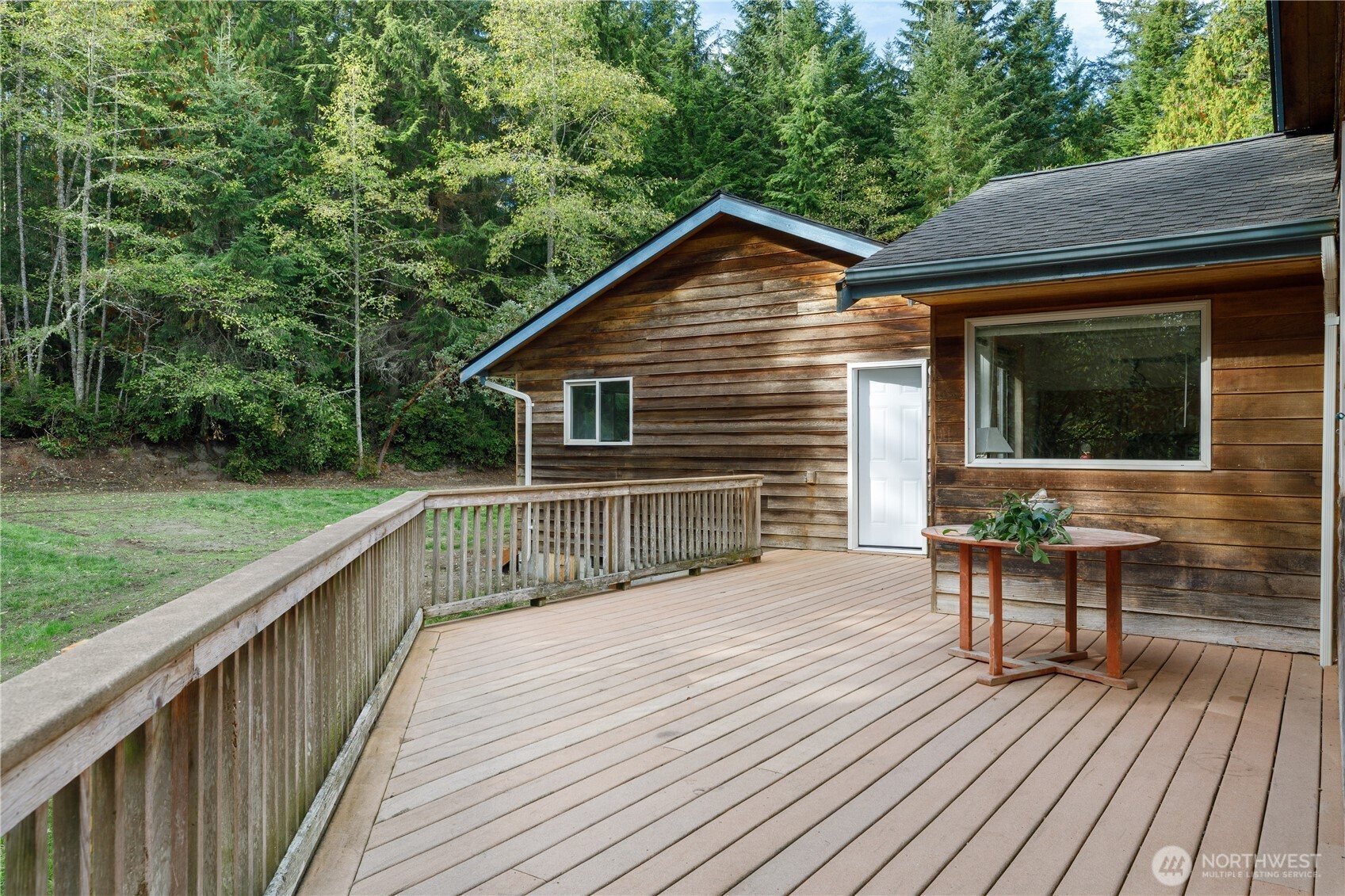 5474 Wilkinson Road Langley, WA 98260 - Photo 27 of 40 a view of house with deck outdoor seating and yard