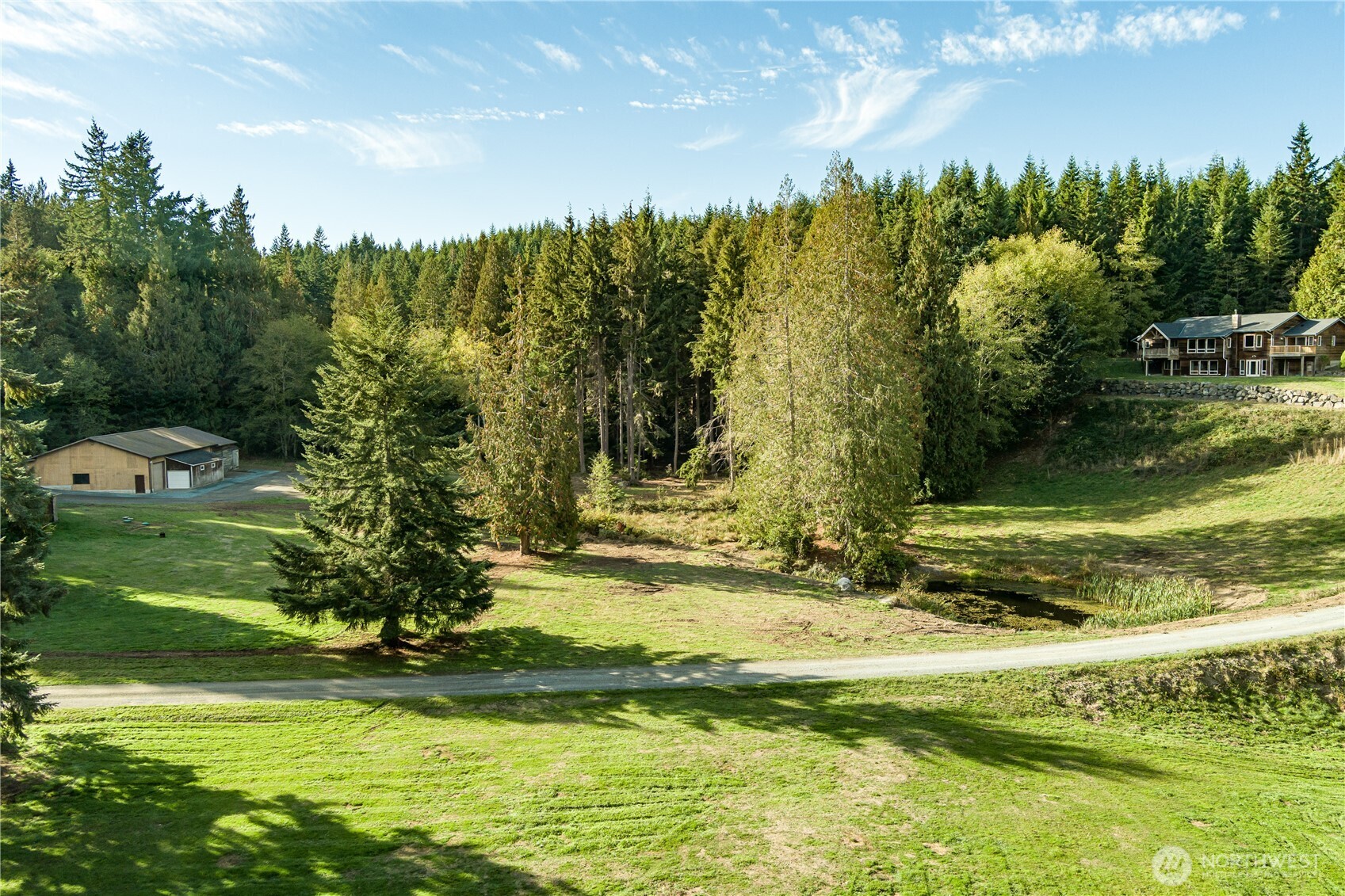 5474 Wilkinson Road Langley, WA 98260 - Photo 31 of 40 a view of a fountain in front of a house with a yard
