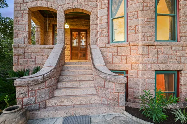 front view of a brick house with a large windows
