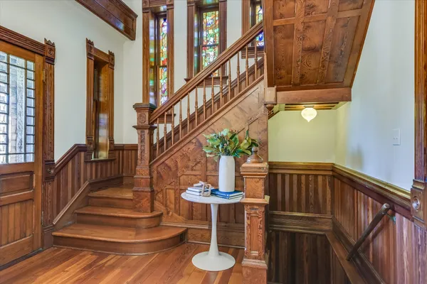 a view of entryway and hall with wooden floor