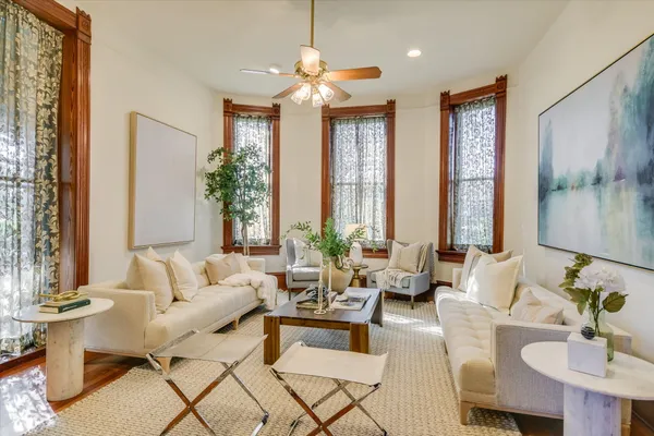 a living room with furniture and floor to ceiling windows