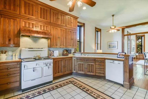a kitchen with granite countertop a sink stove and cabinets