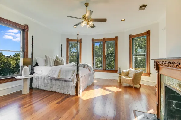 a bedroom with a bed and wooden floor