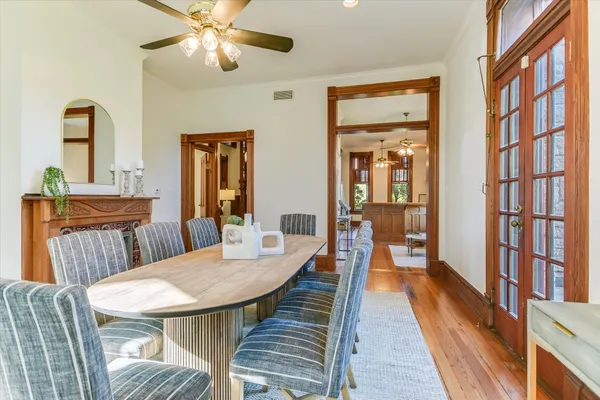a dining room with furniture a window and wooden floor