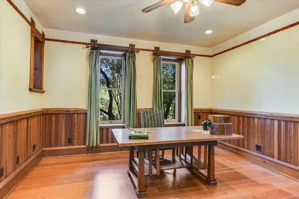 a view of a hallway with furniture and window