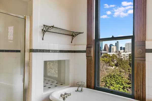 a view of a bathroom with tub and window