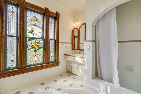 a view of an empty room with glass door and wooden floor