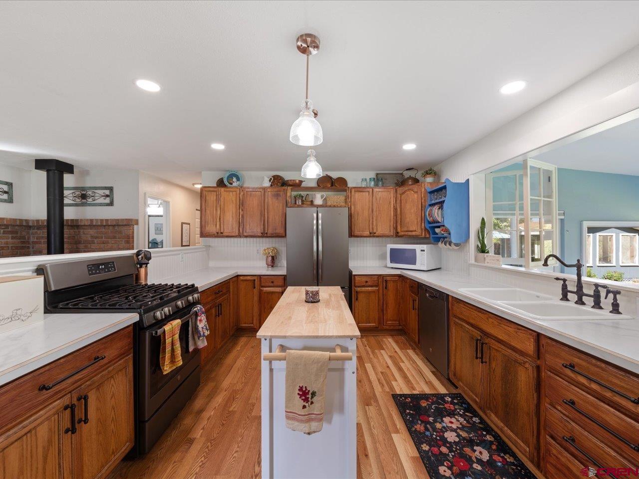 68184 Tumbleweed Road Montrose, CO 81403 - Photo 11 of 35 a kitchen with stainless steel appliances a stove sink and cabinets
