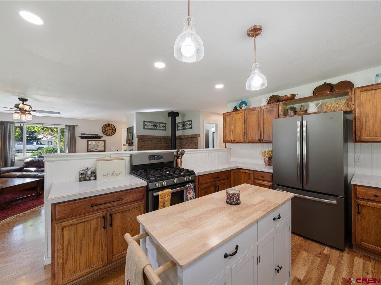 68184 Tumbleweed Road Montrose, CO 81403 - Photo 13 of 35 a kitchen with stainless steel appliances a stove refrigerator sink and microwave