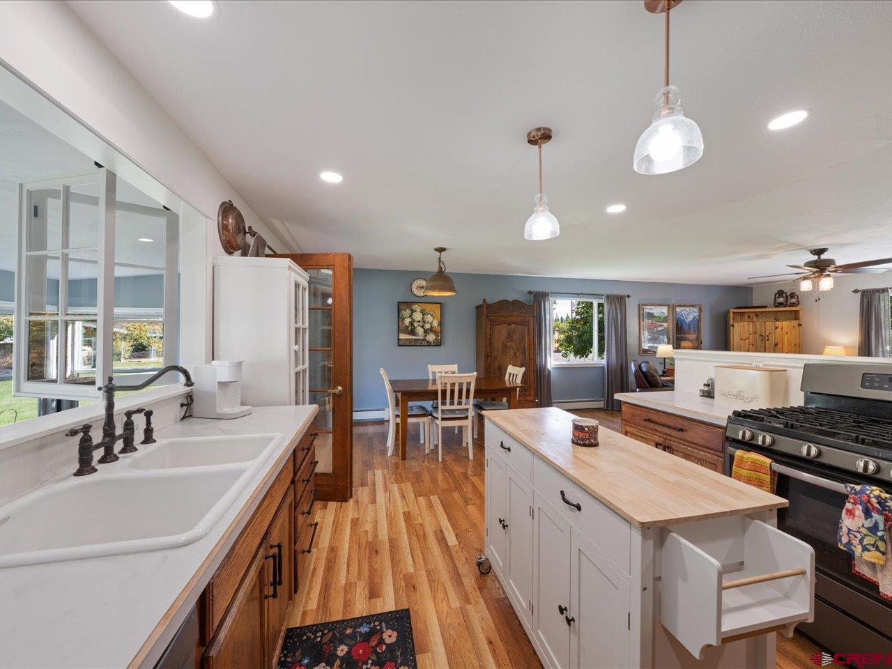 68184 Tumbleweed Road Montrose, CO 81403 - Photo 14 of 35 a kitchen with stainless steel appliances a stove sink and cabinets
