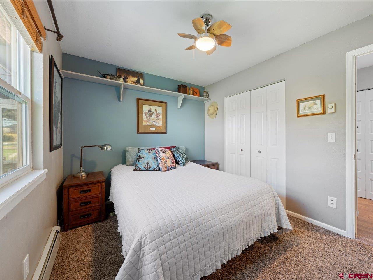 68184 Tumbleweed Road Montrose, CO 81403 - Photo 21 of 35 a bedroom with a bed and a chandelier