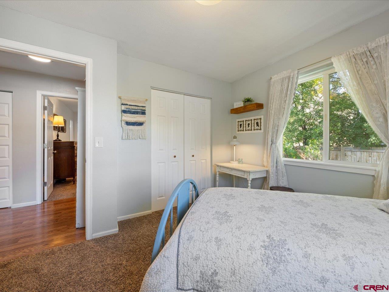68184 Tumbleweed Road Montrose, CO 81403 - Photo 25 of 35 a bedroom with a bed and wooden floor