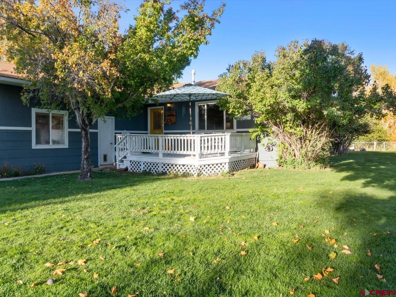 68184 Tumbleweed Road Montrose, CO 81403 - Photo 3 of 35 a front view of a house with garden