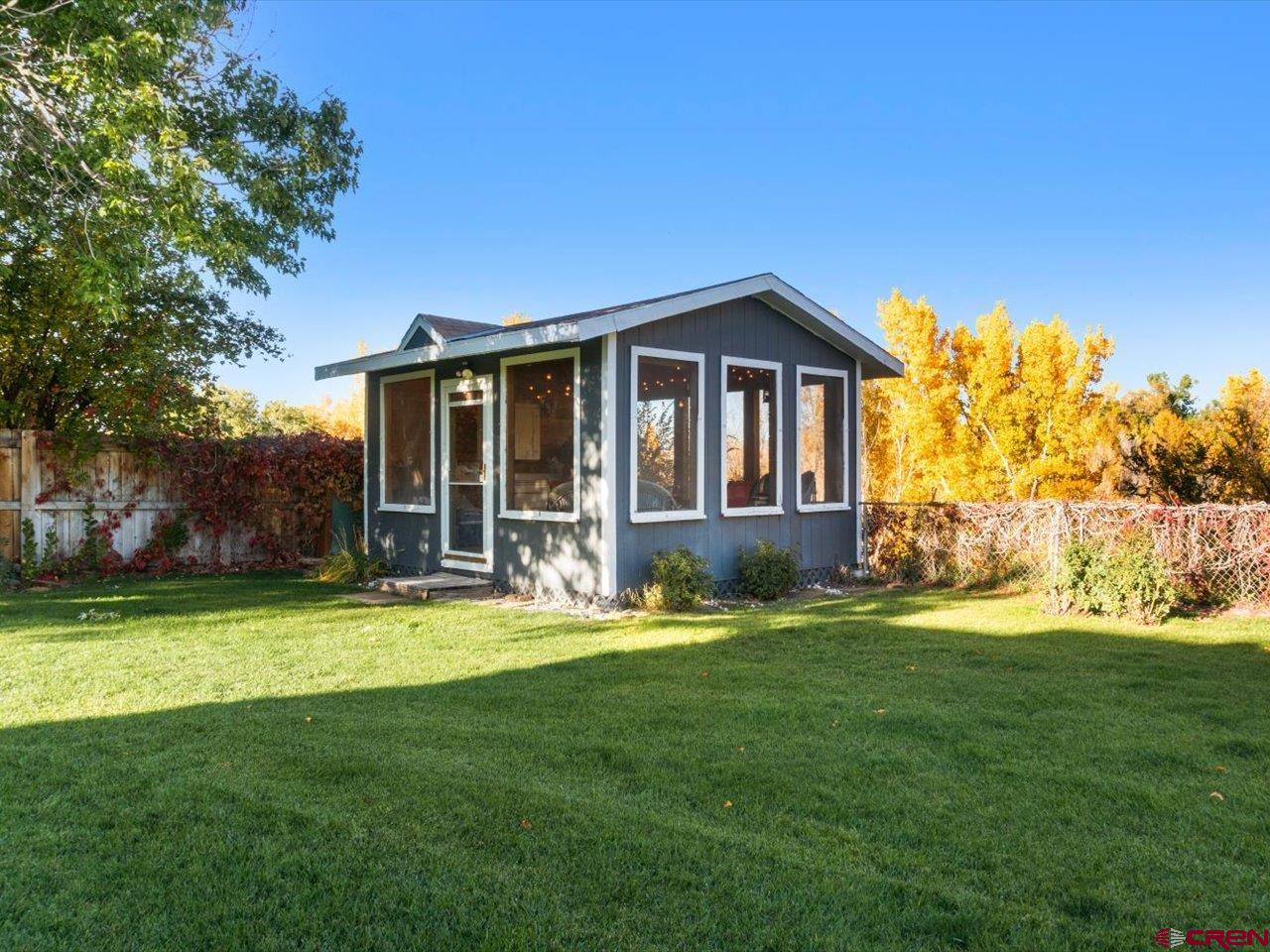 68184 Tumbleweed Road Montrose, CO 81403 - Photo 31 of 35 a front view of a house with a yard