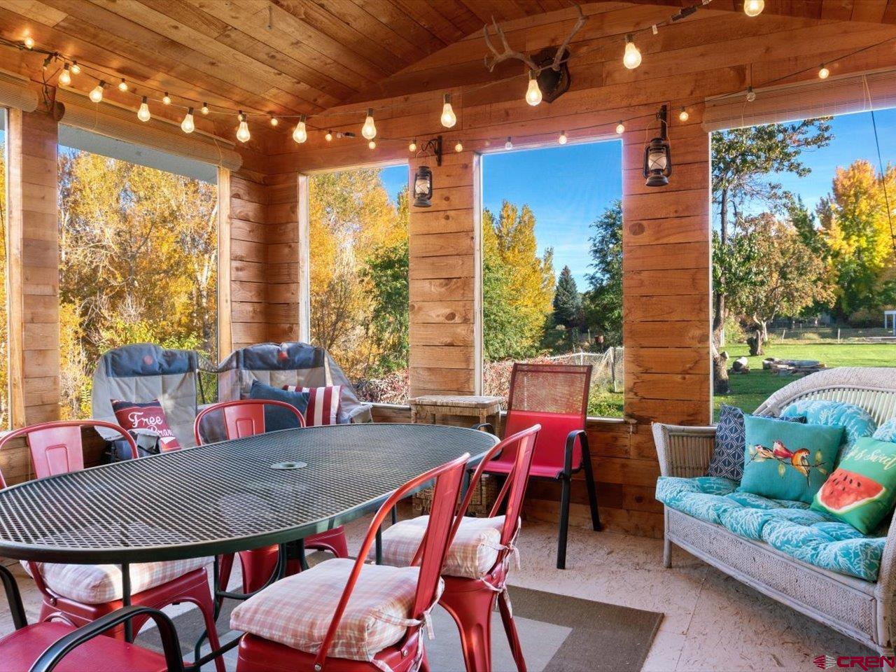 68184 Tumbleweed Road Montrose, CO 81403 - Photo 32 of 35 a dining room with furniture and a garden