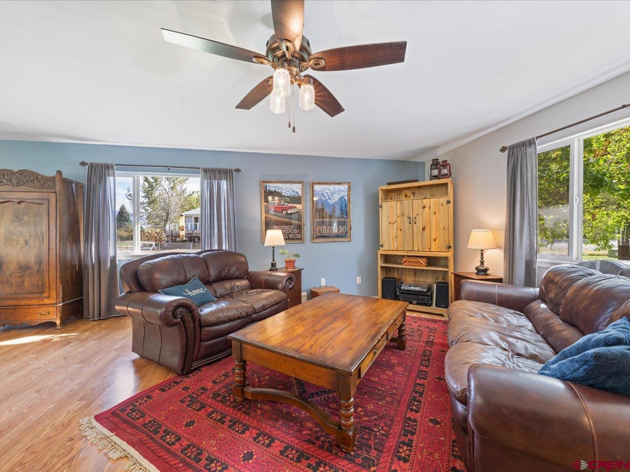 68184 Tumbleweed Road Montrose, CO 81403 - Photo 7 of 35 a living room with furniture a large window and flat screen tv