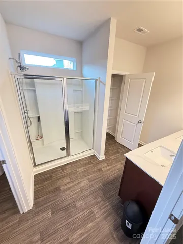 a room with a sink cabinets and wooden floor