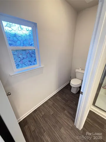 a view of empty room with a car parked in it