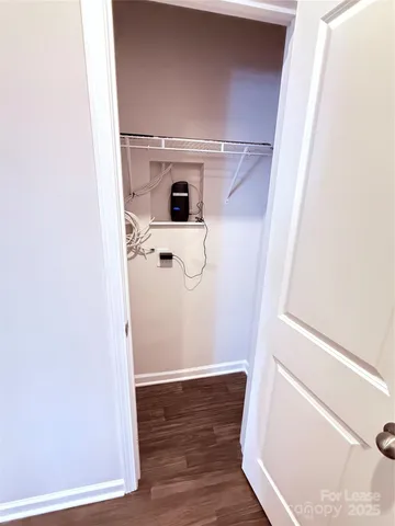 a view of walk in closet with empty racks