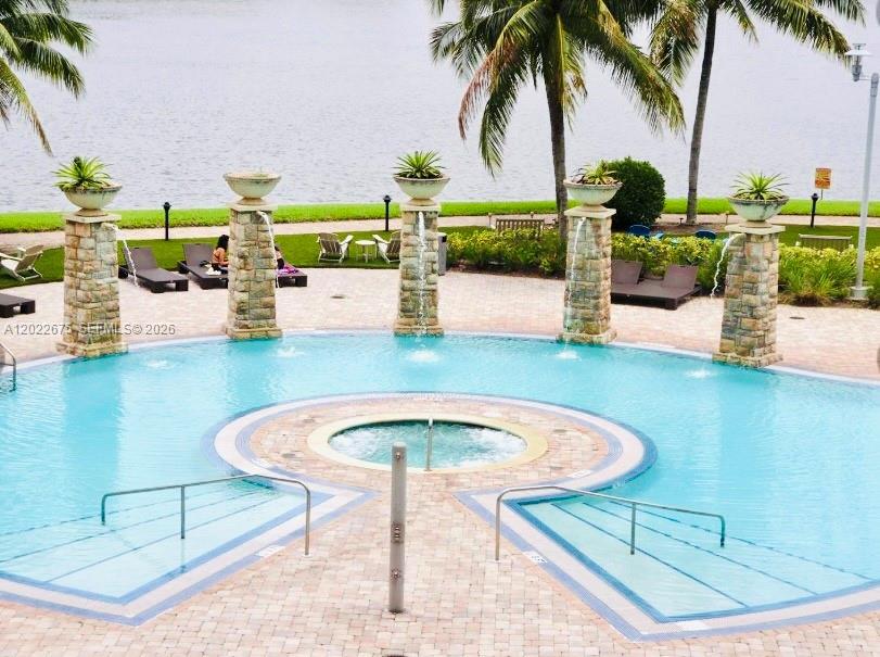 2681 North Flamingo Road, Unit 2602S Sunrise, FL 33323 - Photo 15 of 18 a view of a swimming pool with a lounge chairs