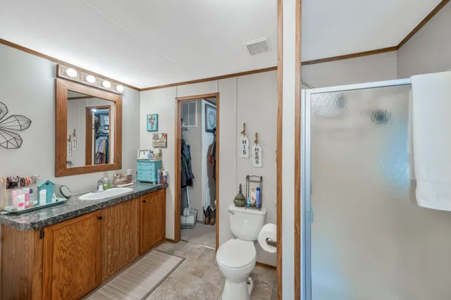 a spacious bathroom with a shower sink mirror and toilet
