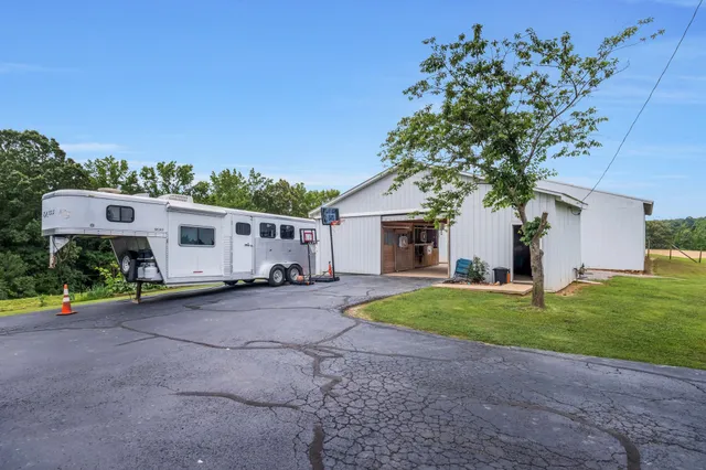 a view of a house with a backyard and a garage