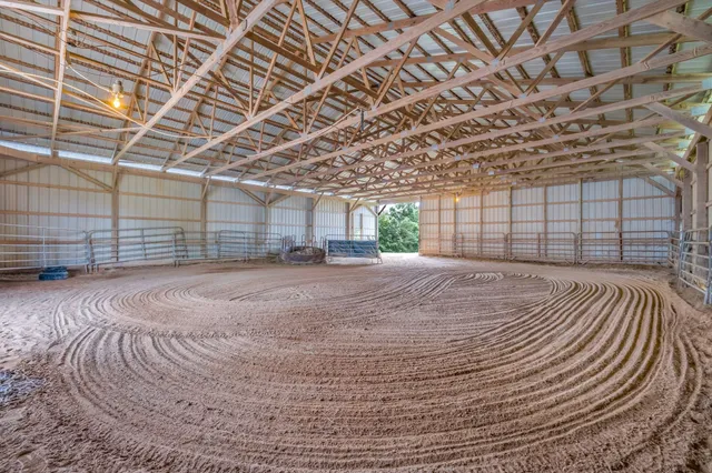 a spacious bedroom with a bed and a chandelier