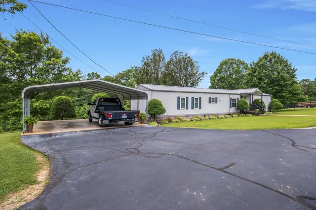 a view of house with outdoor space and swimming pool