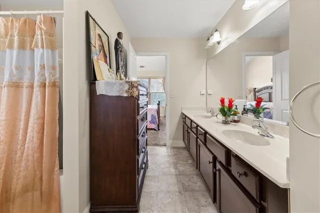 a bathroom with a double vanity sink and mirror