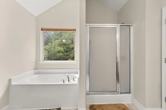 a bathroom with a bathtub and a window