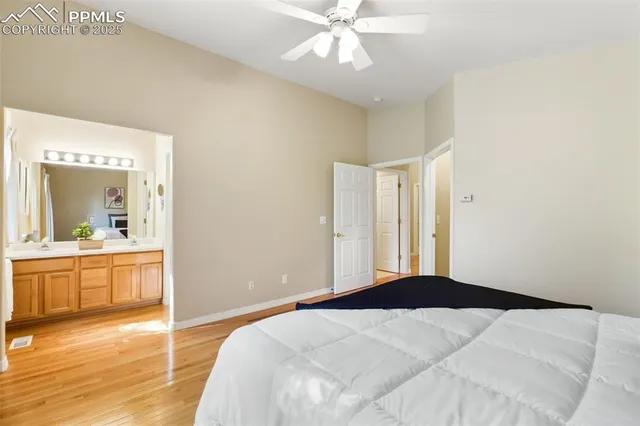a bedroom with a large bed and a chandelier