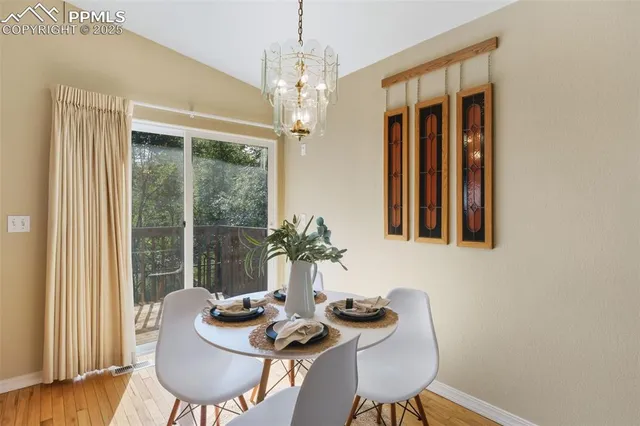 a dining room with furniture a chandelier and window