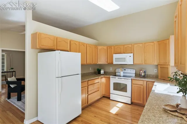 a kitchen with a refrigerator a sink and a stove top oven