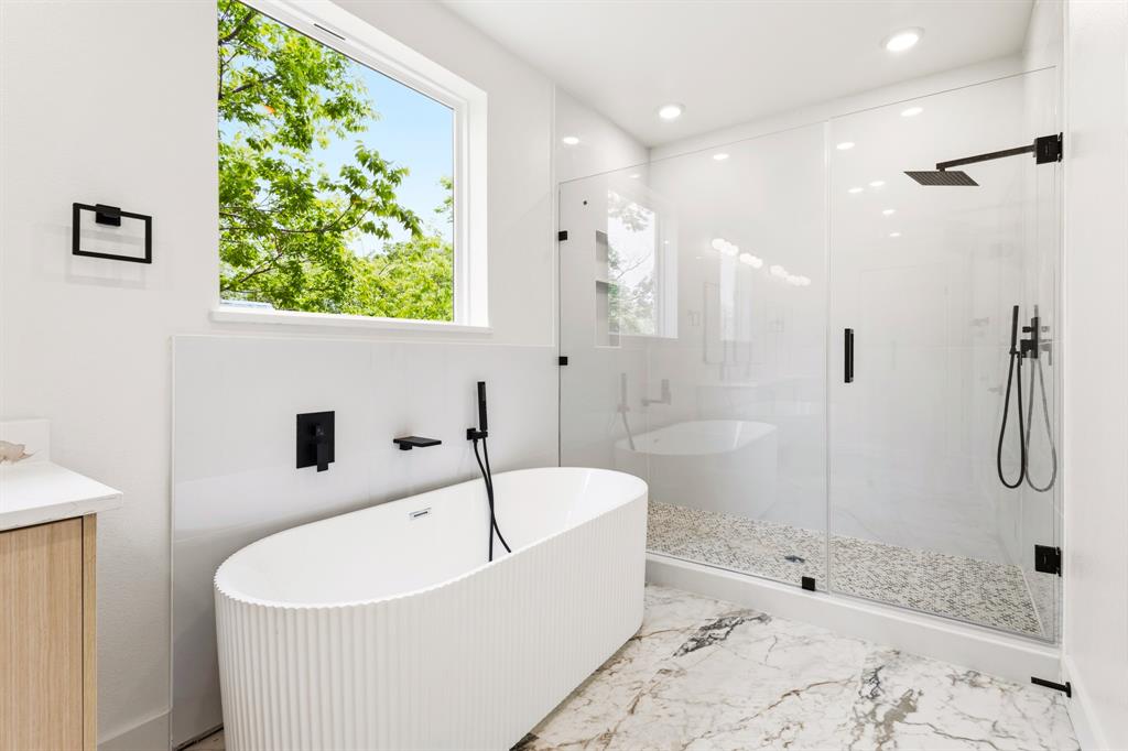 413 North Patton Avenue Dallas, TX 75203 - Photo 11 of 21 a white bath tub sitting next to a shower