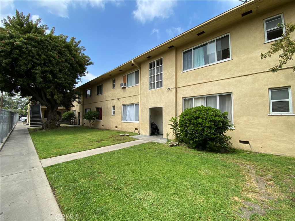 516 East Lomita Avenue, Unit 3 Glendale, CA 91205 - Photo 9 of 9 a view of a white house with a big yard plants and large trees
