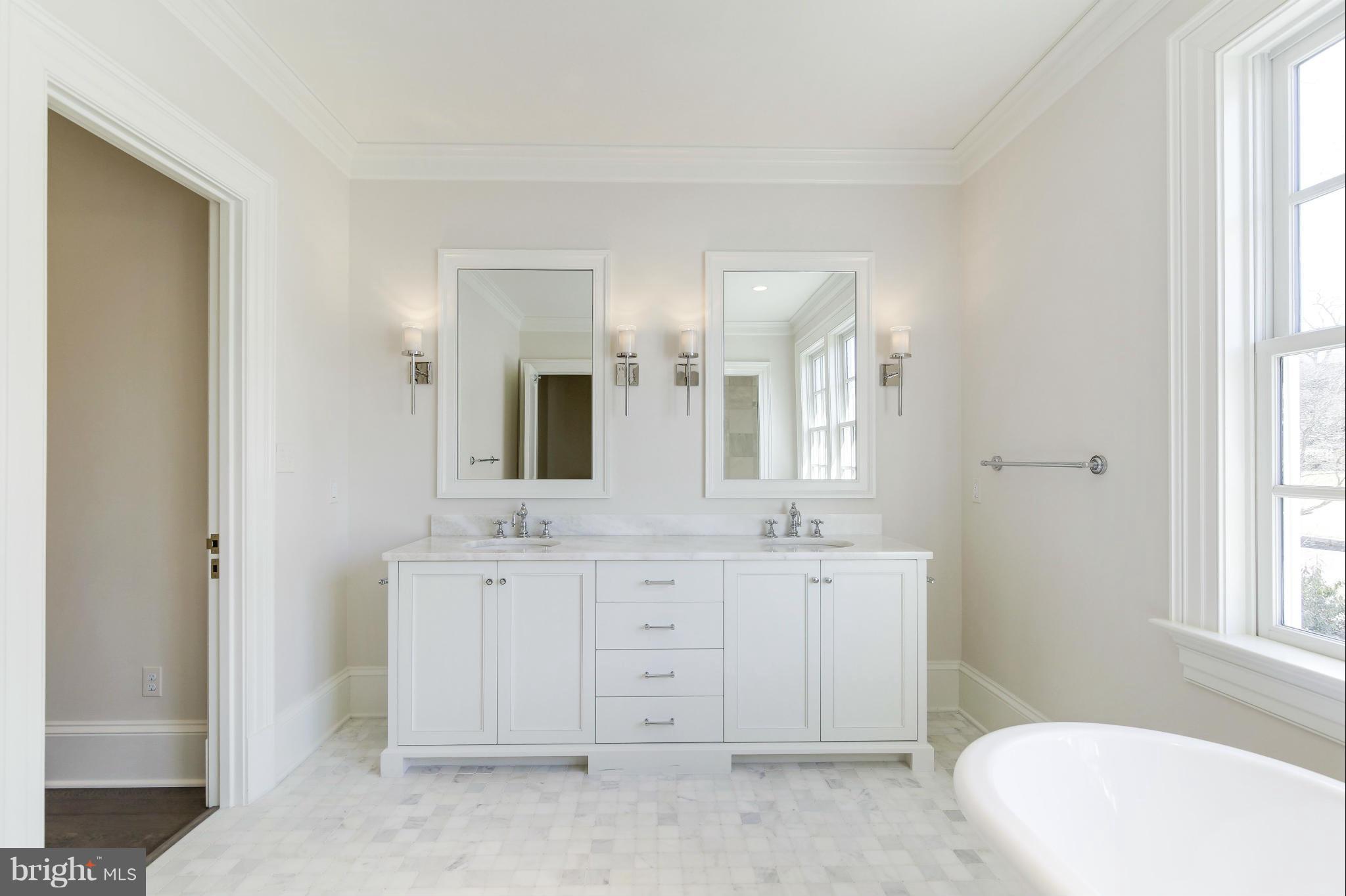 4450 Deerfield Road Washington, DC 20007 - Photo 15 of 28 a spacious bathroom with double vanity sinks a mirror and a bathtub