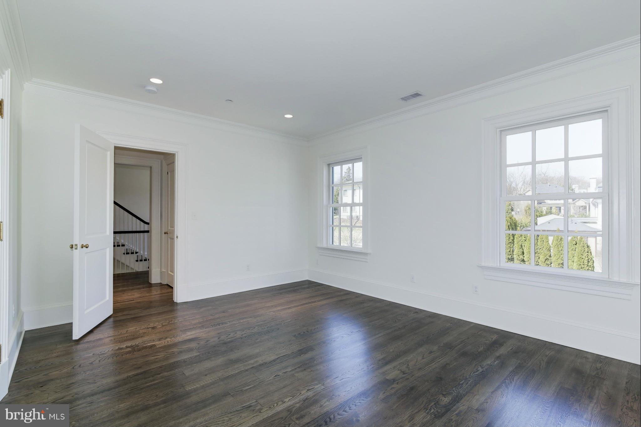 4450 Deerfield Road Washington, DC 20007 - Photo 16 of 28 a view of an empty room with wooden floor and a window