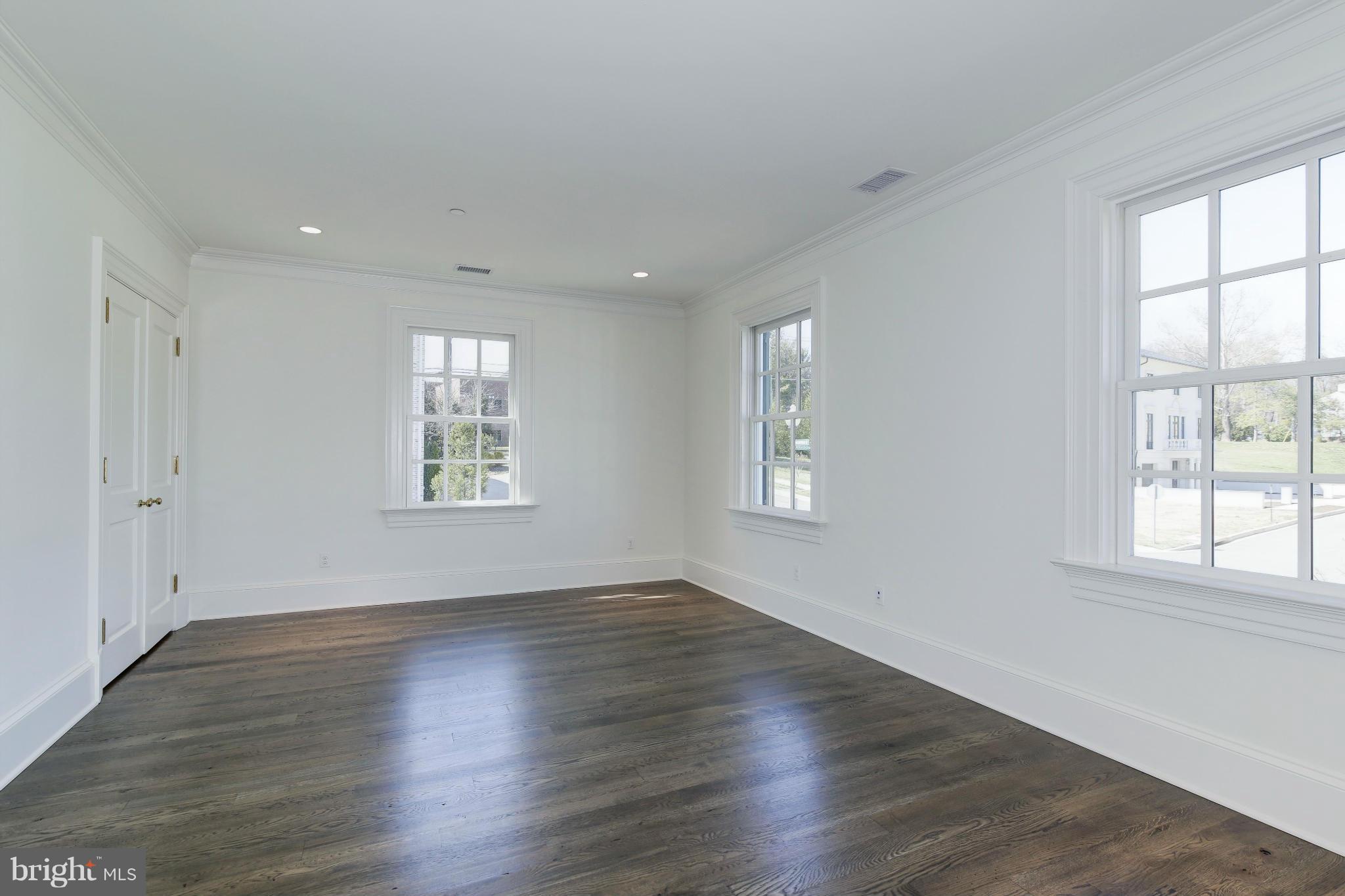 4450 Deerfield Road Washington, DC 20007 - Photo 17 of 28 an empty room with wooden floor and windows