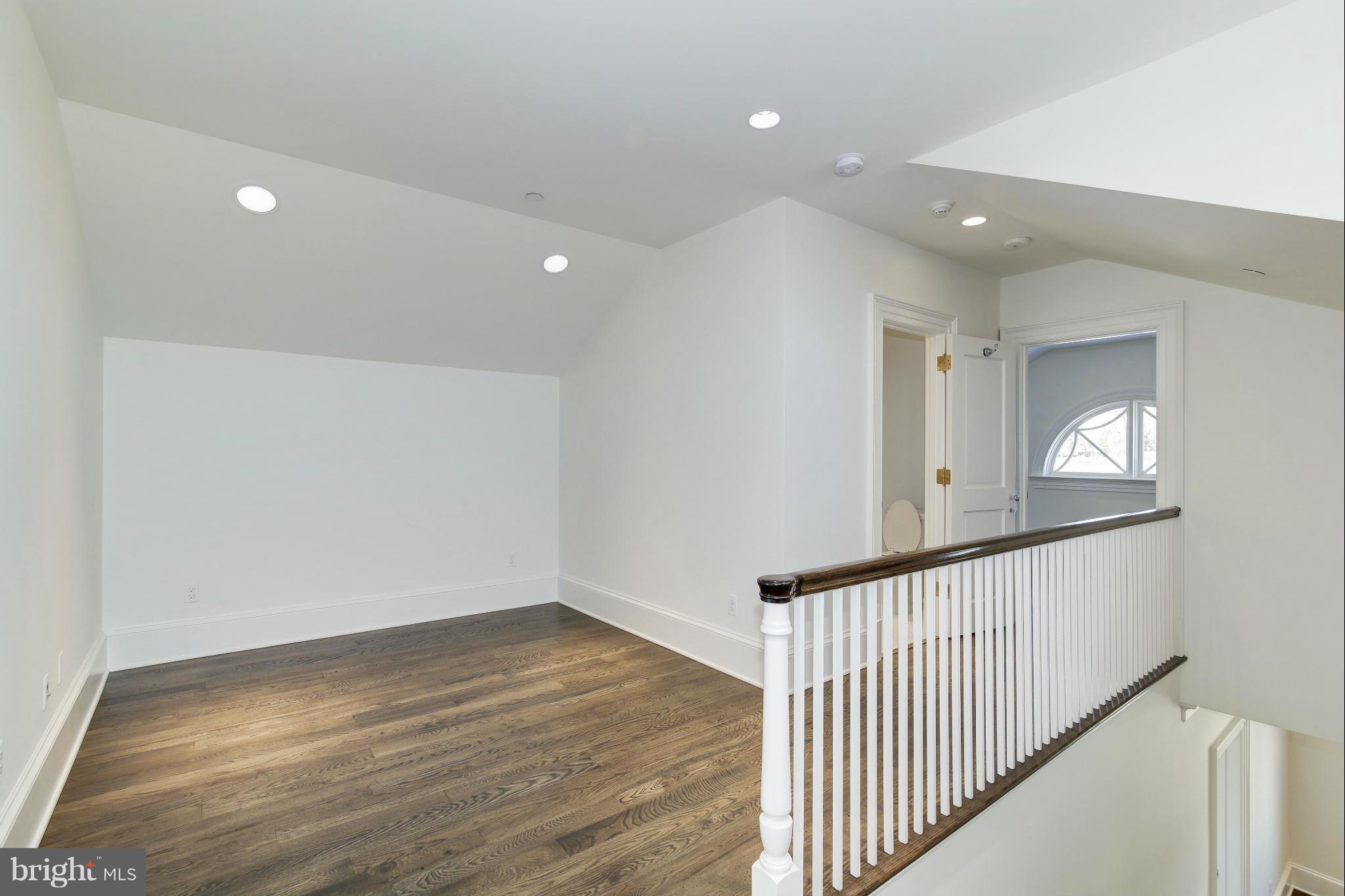 4450 Deerfield Road Washington, DC 20007 - Photo 19 of 28 wooden floor in an empty room with a window