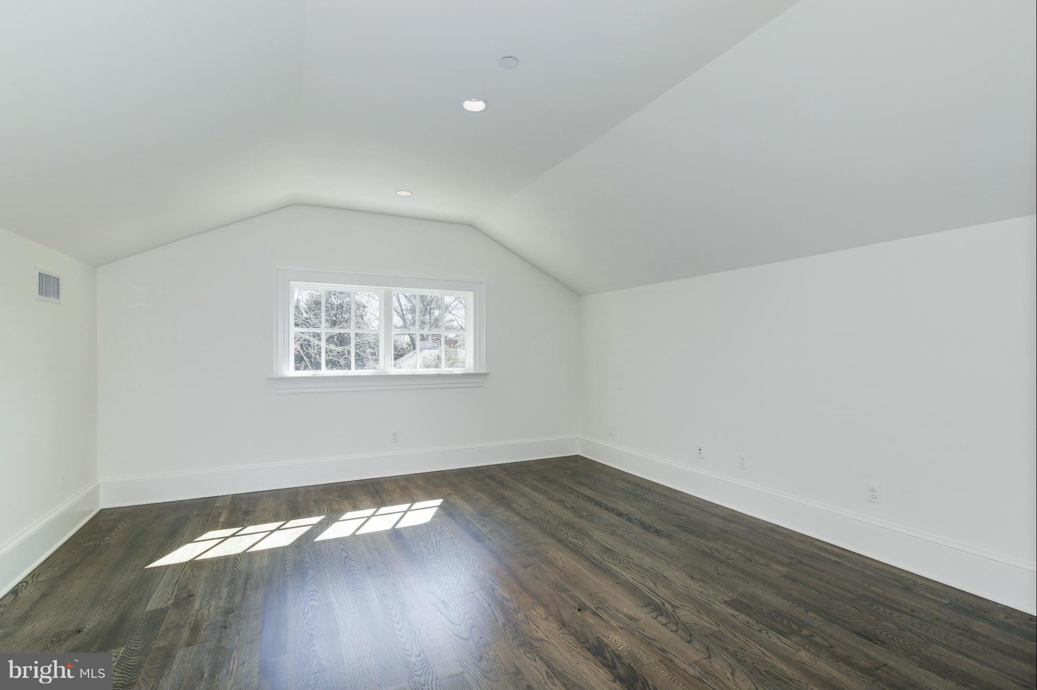 4450 Deerfield Road Washington, DC 20007 - Photo 20 of 28 an empty room with wooden floor and windows