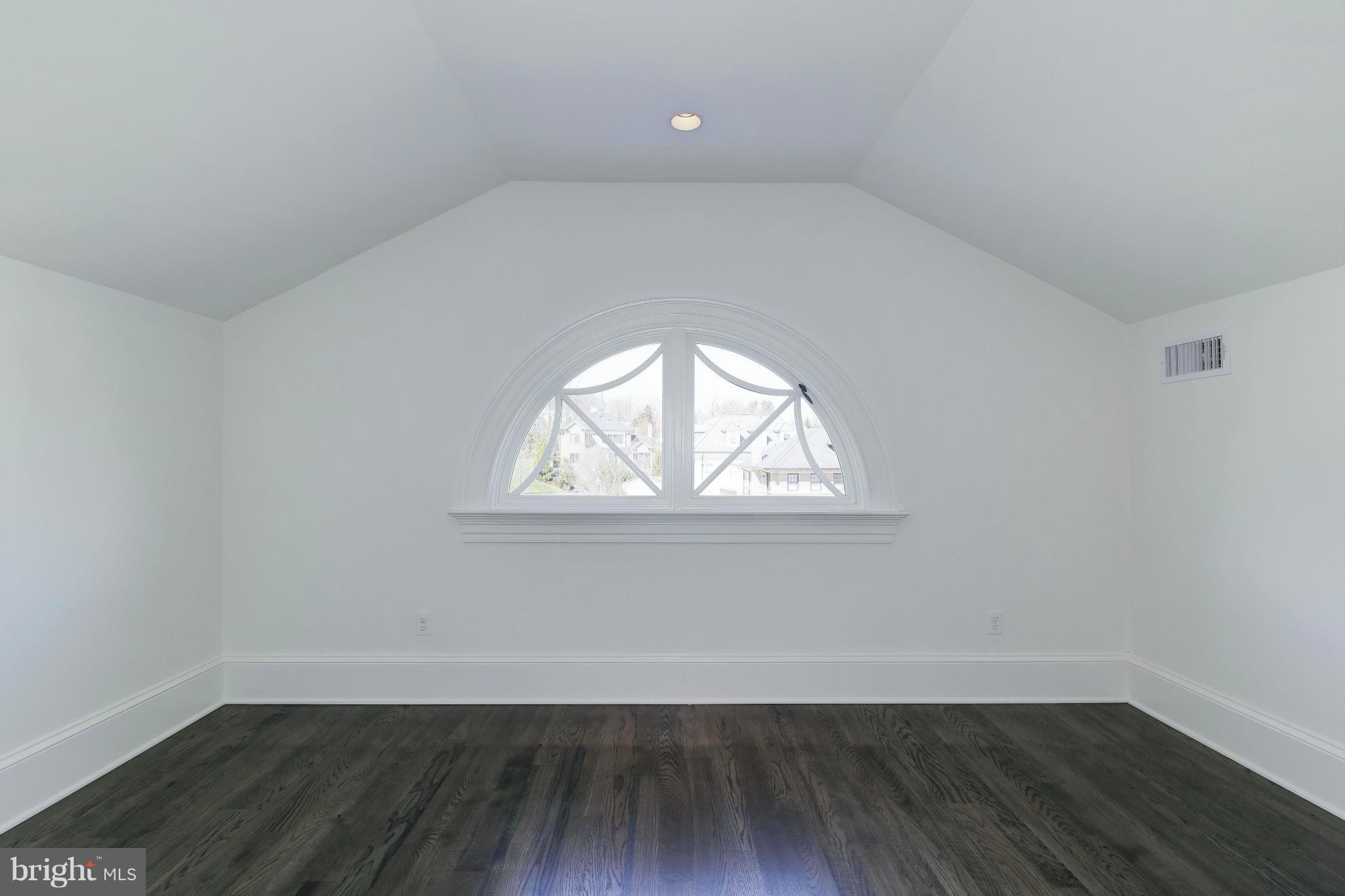 4450 Deerfield Road Washington, DC 20007 - Photo 21 of 28 an empty room with wooden floor and windows