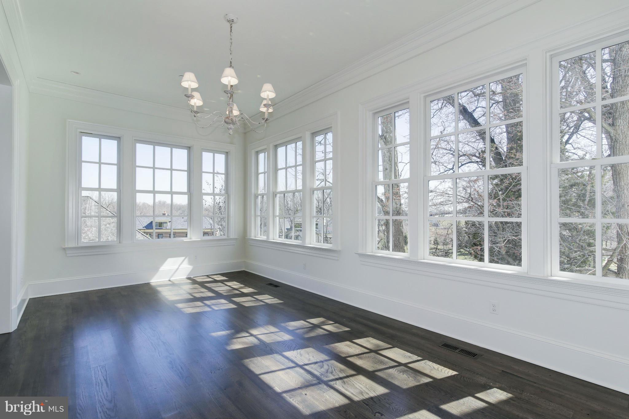 4450 Deerfield Road Washington, DC 20007 - Photo 5 of 28 a living room with hardwood floor and large windows