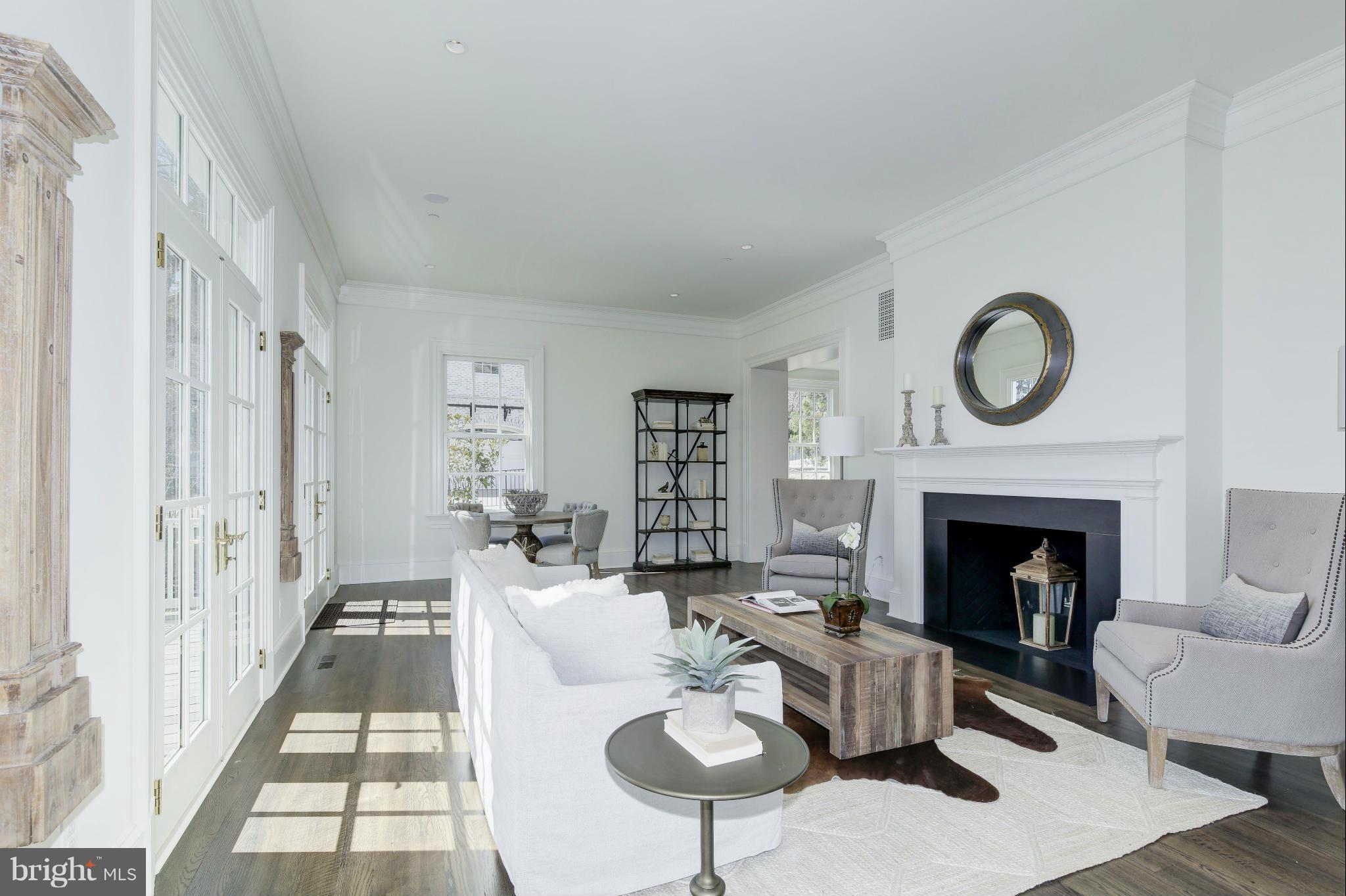 4450 Deerfield Road Washington, DC 20007 - Photo 6 of 28 a living room with furniture a fireplace and a large window