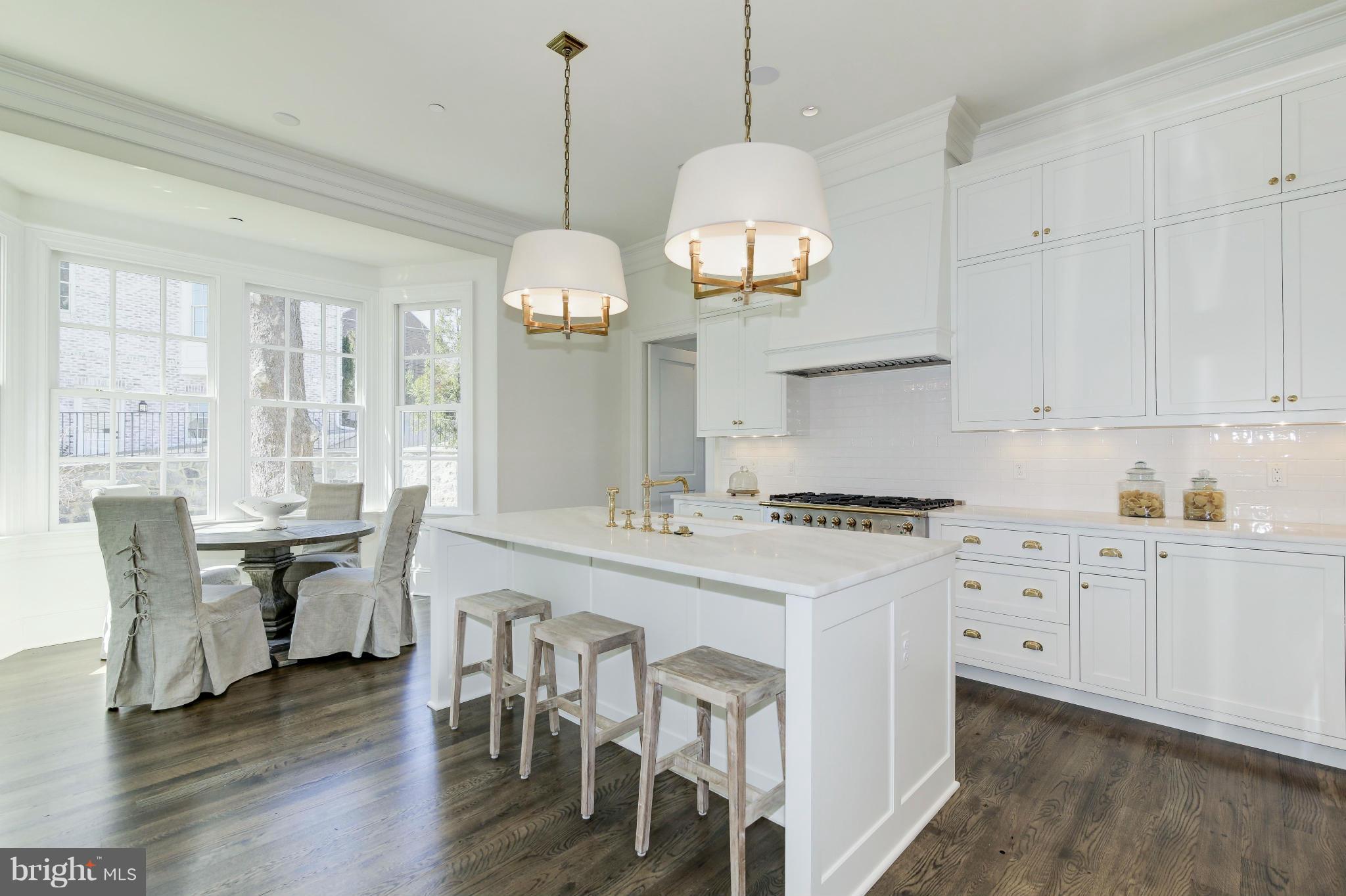 4450 Deerfield Road Washington, DC 20007 - Photo 8 of 28 a kitchen with stainless steel appliances a stove a sink a center island and wooden floor