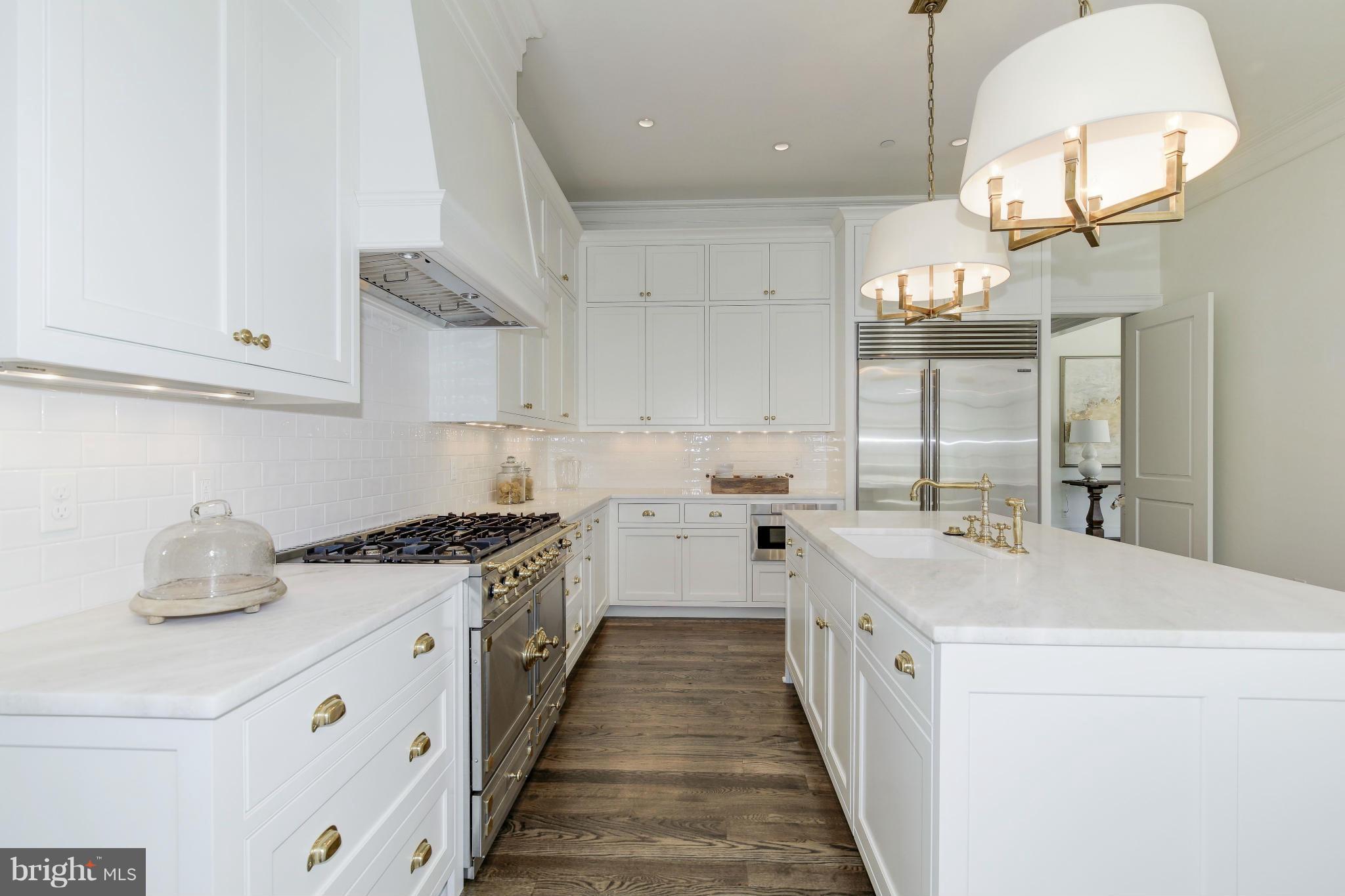 4450 Deerfield Road Washington, DC 20007 - Photo 9 of 28 a kitchen with a sink a stove and cabinets