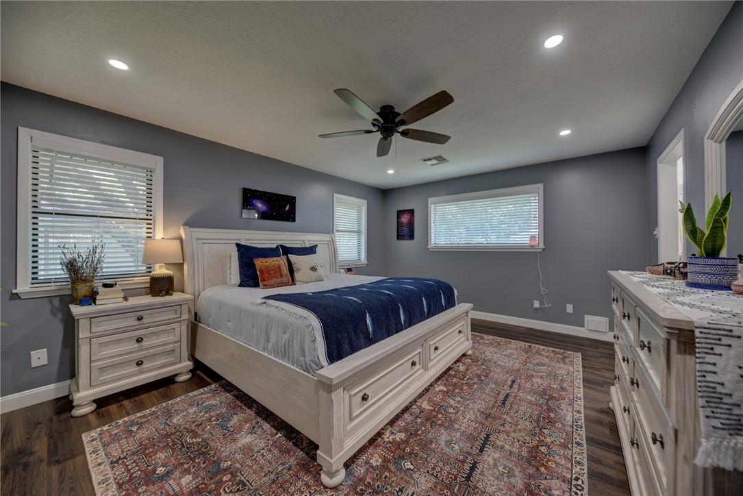 1600 Pecan Street Brenham, TX 77833 - Photo 11 of 33 Bedroom with baseboards, natural lighting, dark wood-style flooring, recessed lighting and ceiling fan