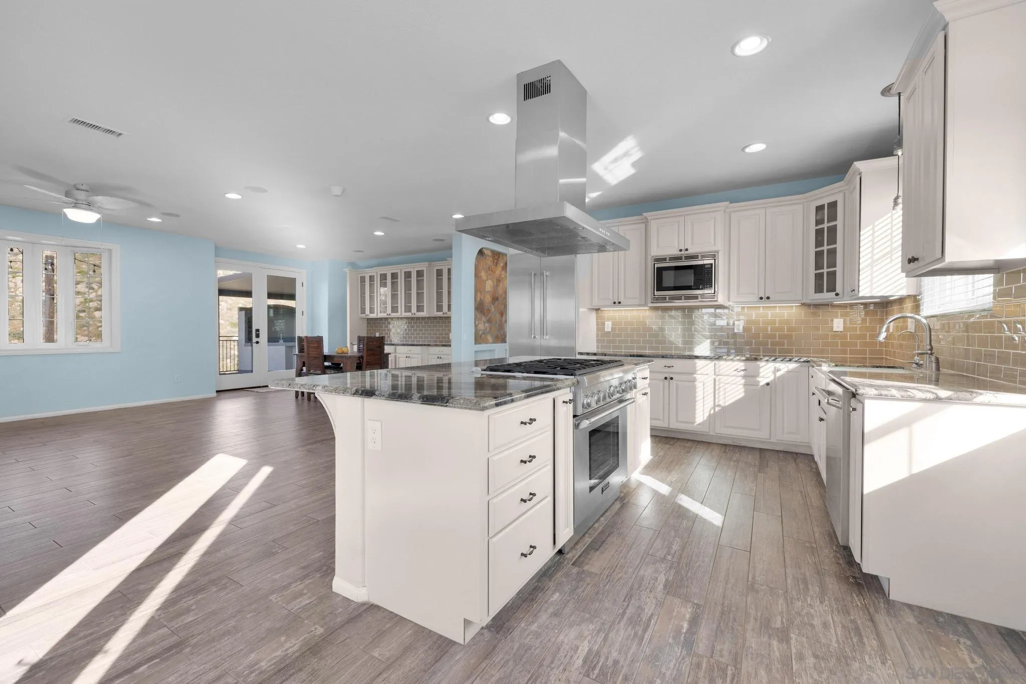 35140 Stirrup Road Temecula, CA 92592 - Photo 13 of 75 a large kitchen with kitchen island a sink a center island stainless steel appliances and a counter top space