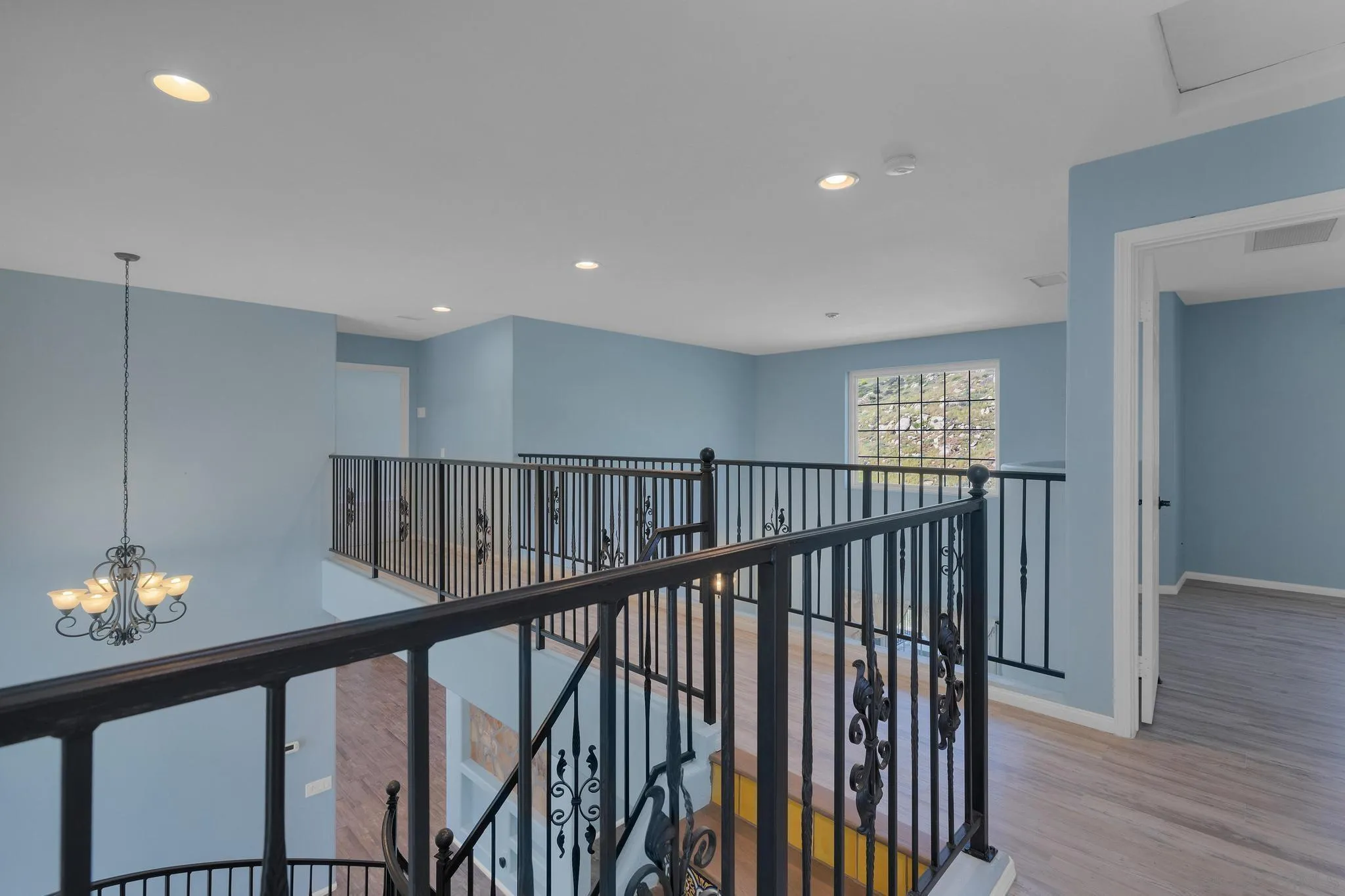 35140 Stirrup Road Temecula, CA 92592 - Photo 25 of 75 a view of a hallway with wooden floor and stairs