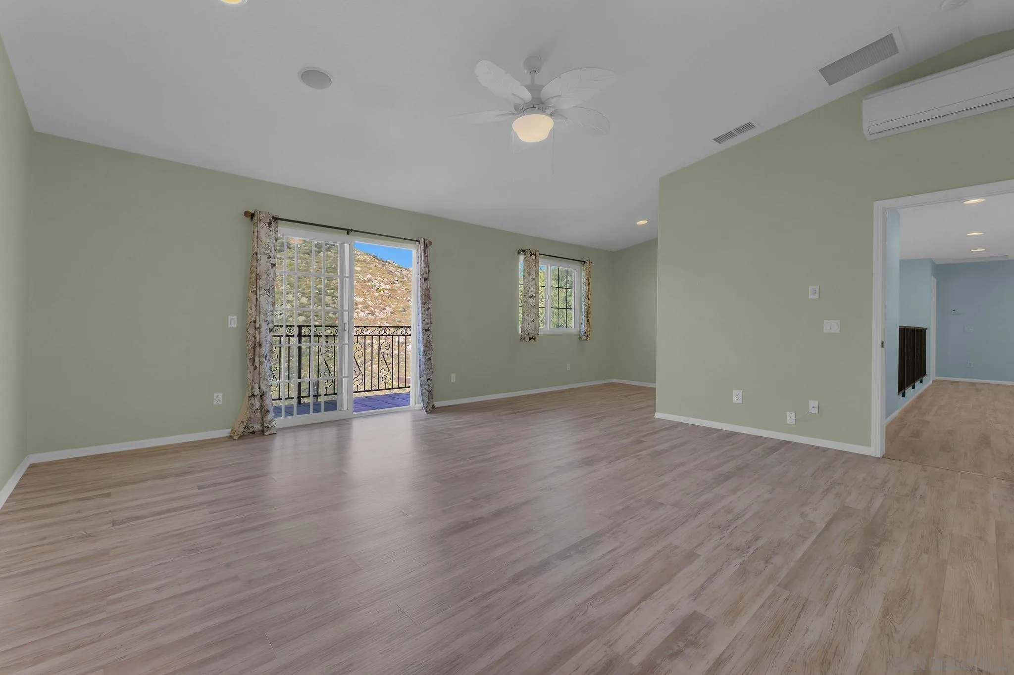 35140 Stirrup Road Temecula, CA 92592 - Photo 26 of 75 a view of an empty room with wooden floor and a window