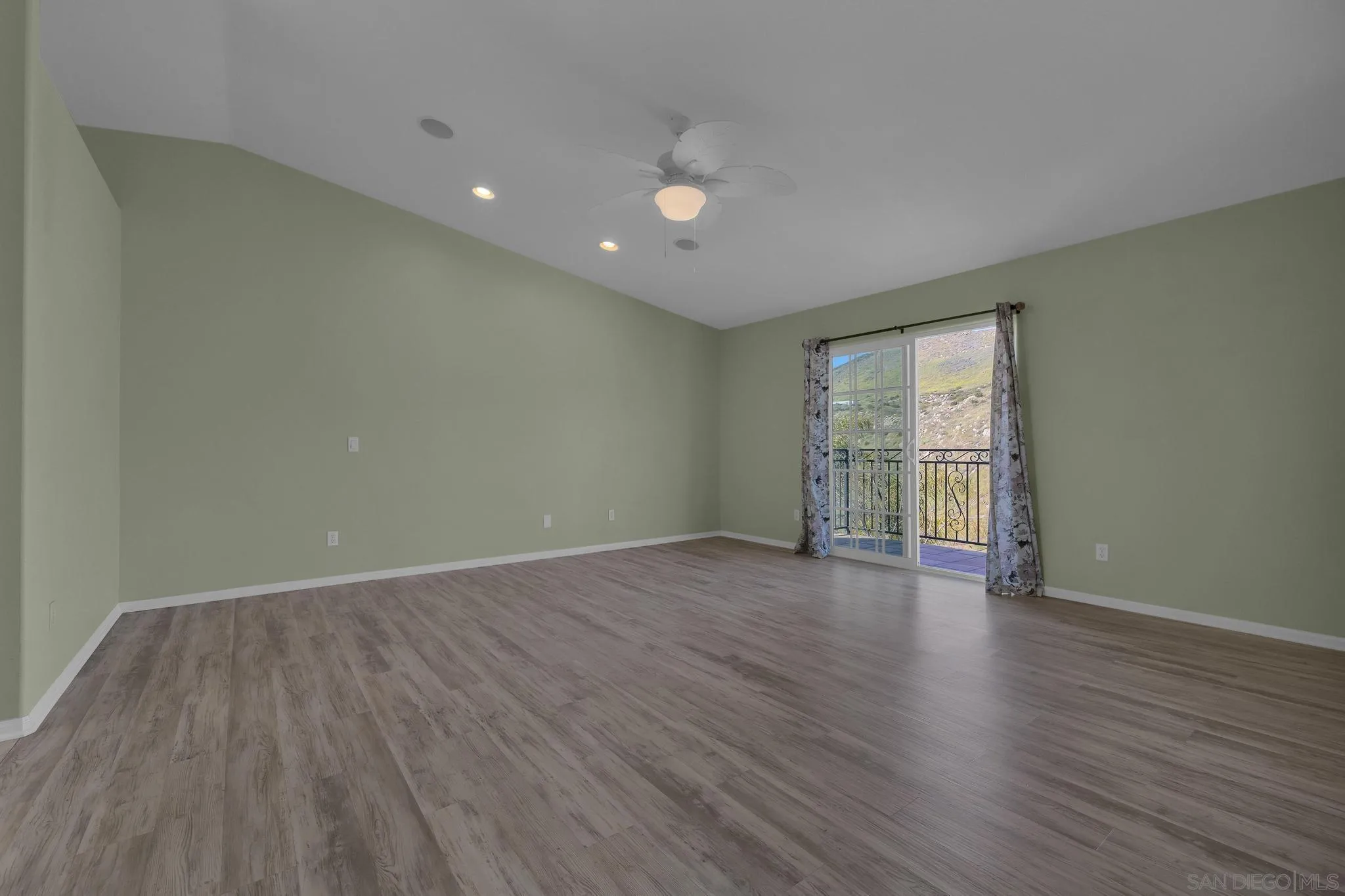 35140 Stirrup Road Temecula, CA 92592 - Photo 28 of 75 an empty room with wooden floor and windows